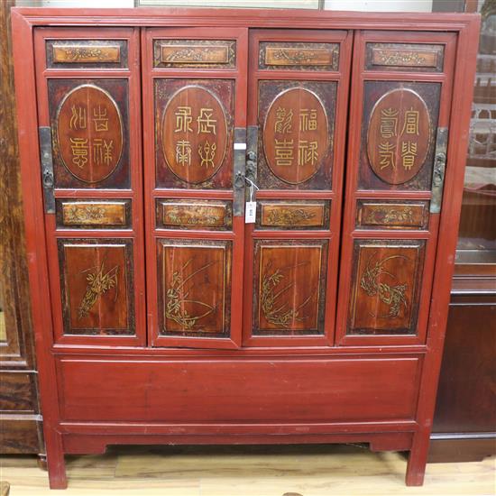 A Chinese lacquered wood four door cabinet W.143cm